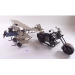 A model 'scrap' aeroplane and a motorbike