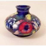 A Moorcroft  squat vase painted in the William Moorcroft Orchid design - signed W. Moorcroft and