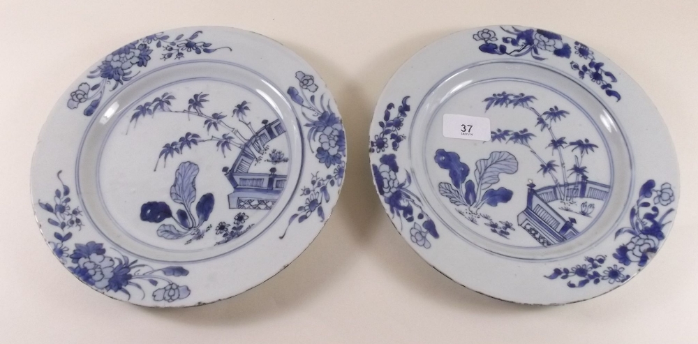 A pair of 18th century Chinese  blue and white plates painted foliage and garden scene