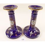 A pair of blue porcelain candlesticks decorated heraldic motifs, 18 cm high