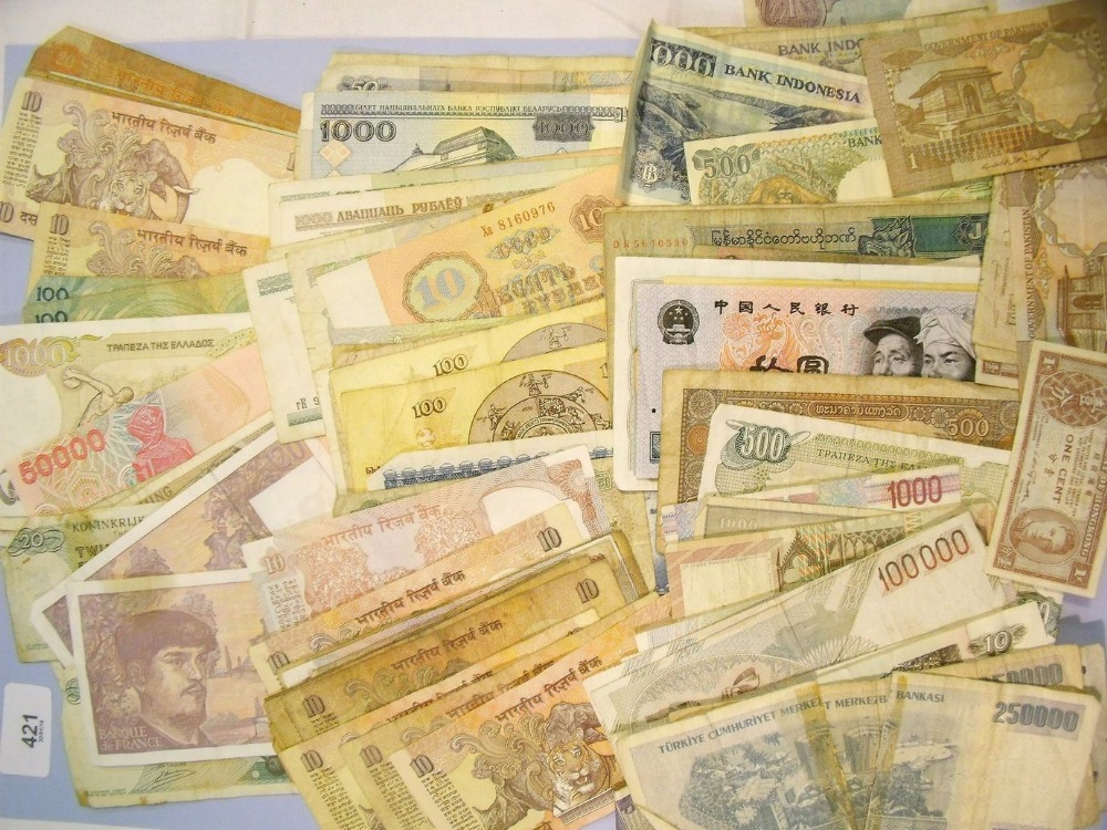 A wad of world banknotes including Europe, Eastern Europe, India and Far East - countries include