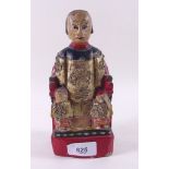 A continental painted wood figure on throne