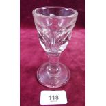 An 18th century wine glass with circular cut facets to bowl