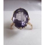 A 14ct gold ring set oval cut large amethyst on decorative mount