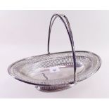 A large silver oval cake basket with pierced decoration and swing handle - Chester