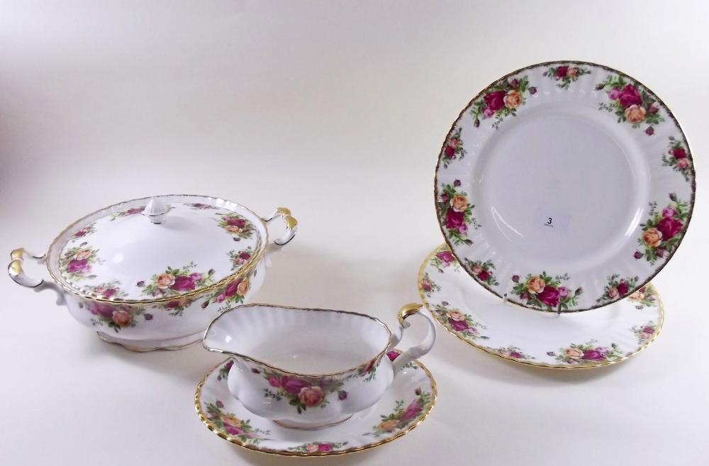 A Royal Albert 'Country Roses' dinner service comprising two tureens, six dinner plates, gravy and