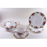 A Royal Albert 'Country Roses' dinner service comprising two tureens, six dinner plates, gravy and
