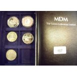 A presentation case - MDM crown collections Ltd. including 3 silver commemorative coins, 2 copper