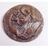 A Chinese brass circular brooch decorated dragons - 7cm diameter