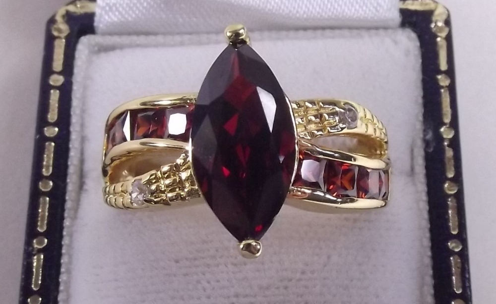 A 10 carat gold ring set red stones