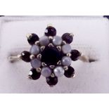 A 9 carat gold garnet and opal cluster ring