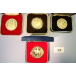 Four cased silver crowns and medals