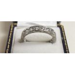 An 18 carat gold eternity ring set white sapphires