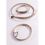A pair of rolled gold snake form bracelets for the upper and lower arm with another rolled gold