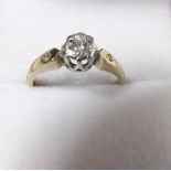 A 9 carat gold ring set diamond on diamond set shoulders