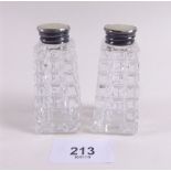 A pair of cut glass, mother of pearl and silver mounted pepper pots