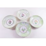 Four Spode green border dishes painted floral reserves