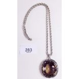 A large silver mounted smokey quartz pendant and chain
