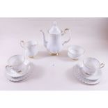 A Royal Albert white teaset including 6 cups and saucers, 6 teaplates, 1 coffee pot, 1 milk jug