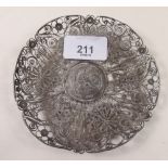 A white metal filigree dish with Chinese coin to centre