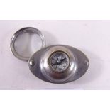 A pocket compass with integral eye glass