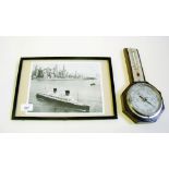 An old photograph of HMS Liberty sailing past New York and a barometer