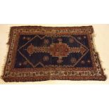 A Turkoman style rug with geometric decoration on blue ground