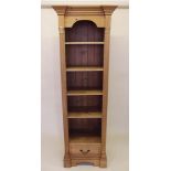 A tall narrow pine bookcase with pillastas to sides