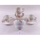 An Art Deco teaset comprising: ten cups and twelve saucers, two jugs, two sugars, two cake plates