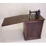 A sewing machine in oak cabinet
