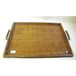 An Edwardian oak tray with turned handles