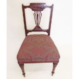 An Edwardian salon chair with carved decoration