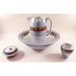 An Edwardian blue lustre four piece toiletry set comprising jug, bowl, soap dish and toothbrush mug