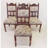 A set of four Victorian mahogany dining chairs with Arts and Crafts caved flower and berry