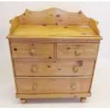 A Victorian pine chest of two short and two long drawers with raised gallery to back - 35" wide