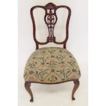 A Victorian chair with carved shell and scrollwork to back