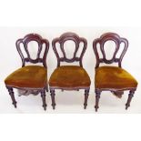 A set of six Victorian mahogany balloon back dining chairs on turned supports