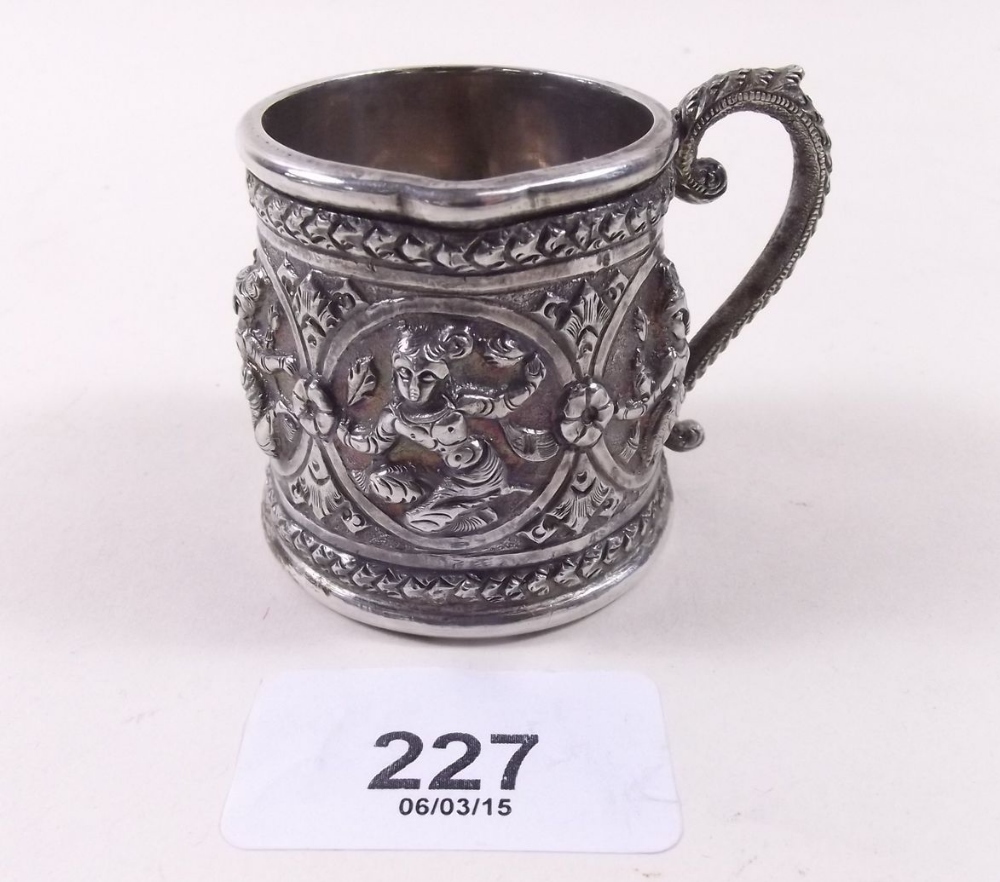 A small Indian white metal jug decorated dancers - 2.6 ozs