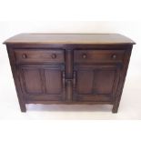 An Ercol sideboard with two drawers over cupboard