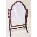 A 1920's mahogany swing toiletry mirror on spindle supports