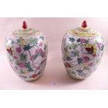 A pair of reproduction Chinese jars and covers - one a/f