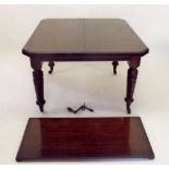 An Edwardian mahogany windout dining table on turned supports with interleaf and winding handle