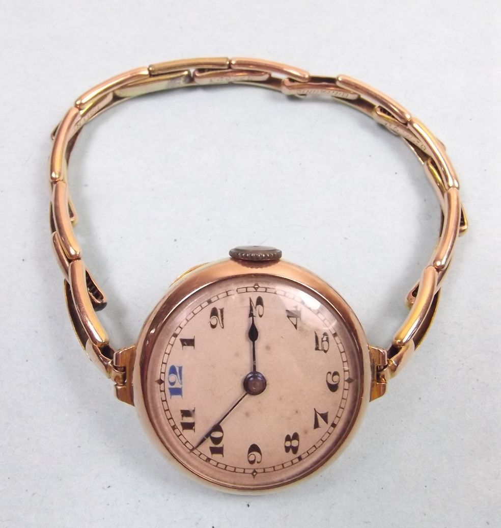 A 9 carat gold ladies wrist watch on 9 carat gold strap