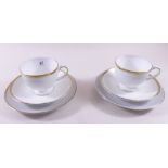 A Wedgwood set of six gilt and white teacups and saucers and six Thomas similar side plates