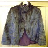 A vintage silk lined fur cape.