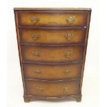 A walnut chest of five drawers