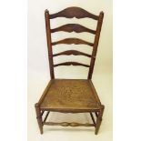 A  19th century elm seated ladder back chair