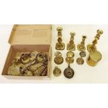 A box of brass candlesticks and bells