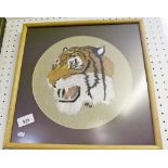 An embroidered picture of a tigers head - framed and glazed 24cm diameter