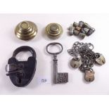 A large padlock and key, another large key, various brass thimbles, two silver thimbles, a set of